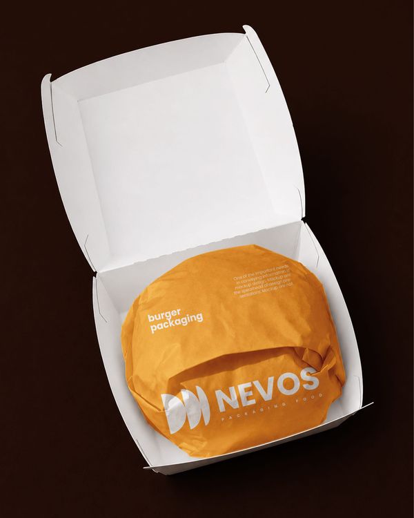 Open burger food box mockup with an orange hamburger wrapper, minimalist branding, and white takeaway packaging presented against a dark brown background.