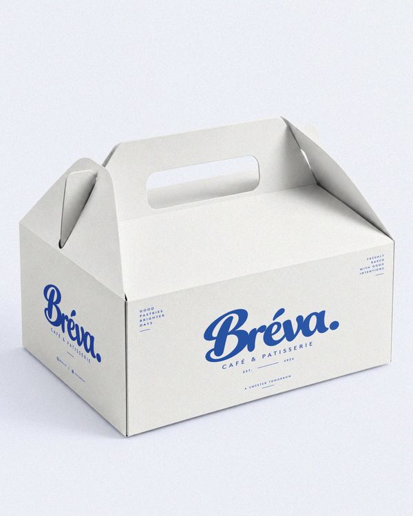 Pastry takeaway box mockup featuring a premium white cardboard box with a built-in handle and elegant blue Bréva branding, presented on a clean studio background.