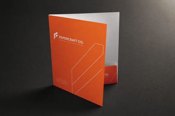 Modern presentation folder mockup with a bold orange design and realistic premium paper finish.