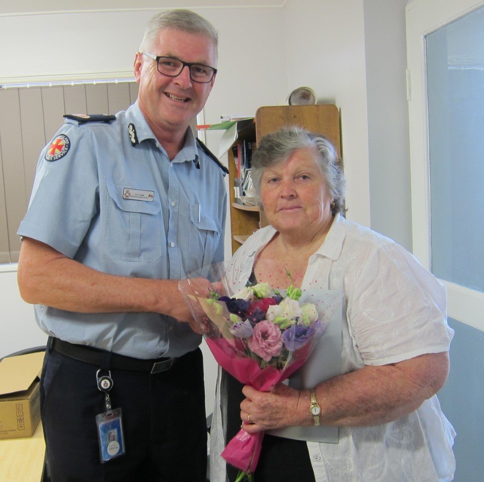 Lillian Clark being presented with her 40 years of service medal by Acting Assistant Commissioner, Ian Tar
