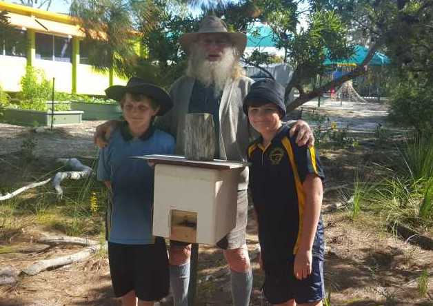 Brydon and Chase helping Cecil install the new bee hives