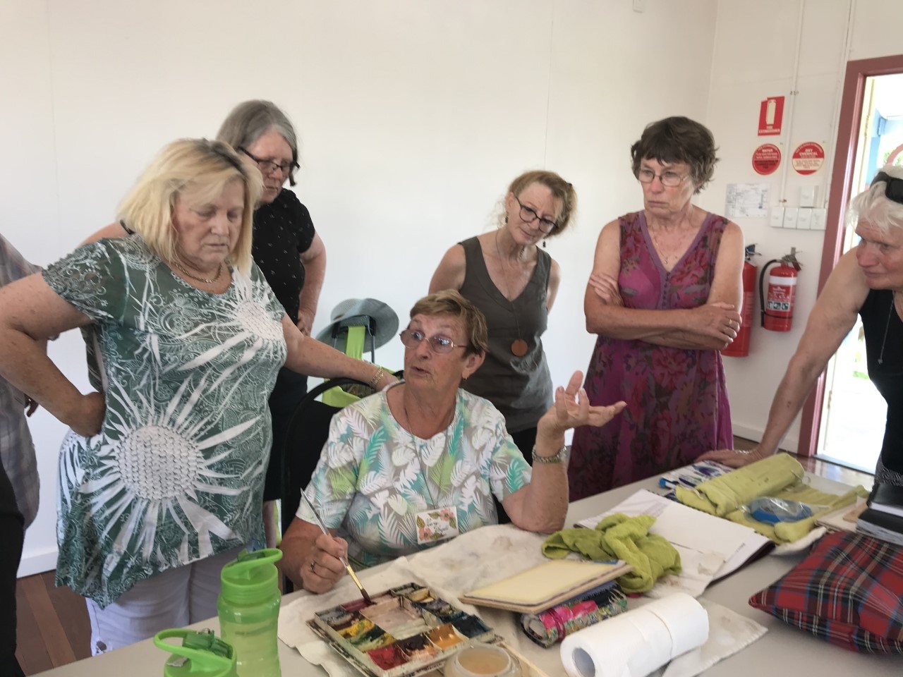 Photo: Members being given the “how to” of watercolour L-R: Rae Donnell, Susan Riddett, Lee Bubb, Kay Muir, Lies Donovan and artist Mary Argall, centre 