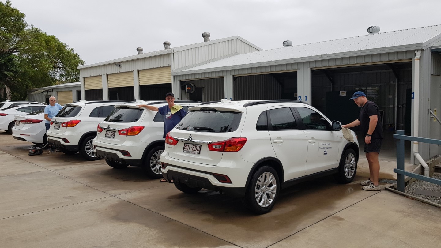 Volunteers David Copus, Brad Wands and Andrew Yeeles getting the Medical Transport vehicles ready for clients 