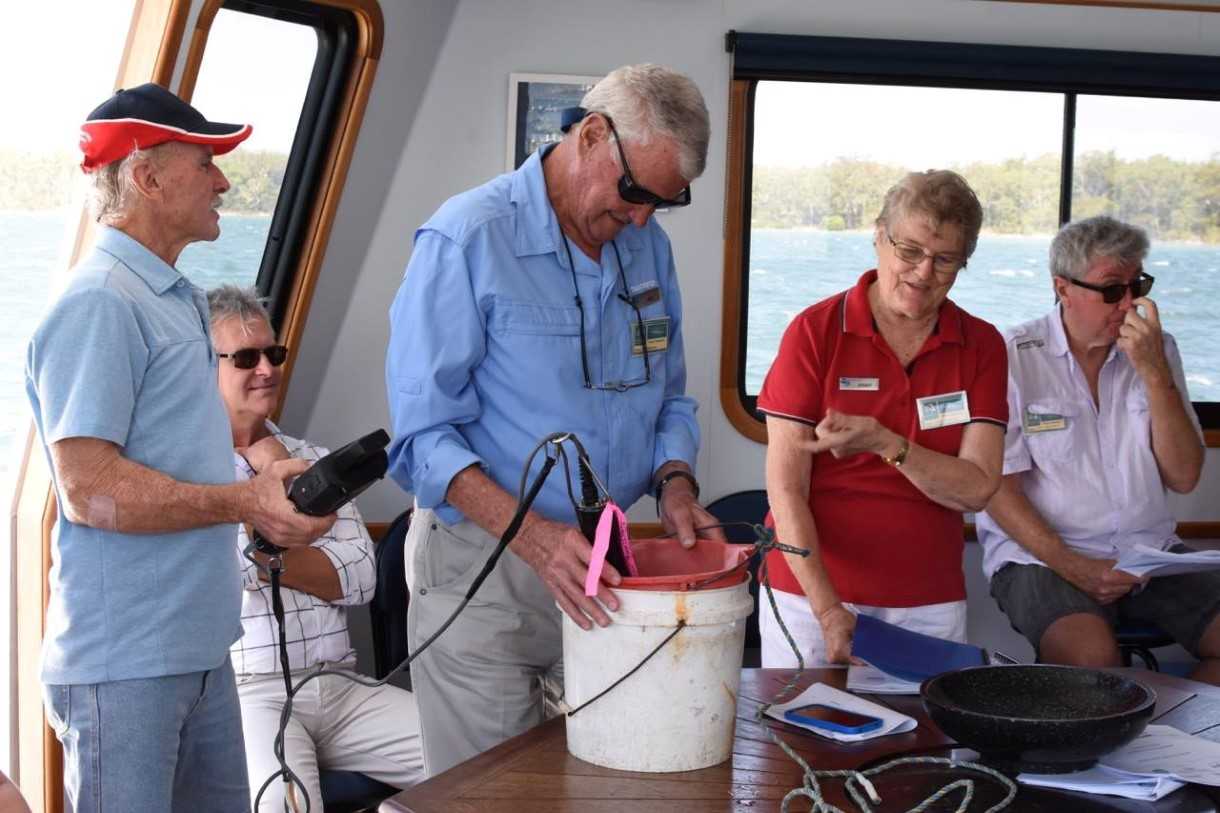 Tin Can Bay waterwatchers, Alan Jones with Bill and Jenny Adamson enjoy the end of year cruise