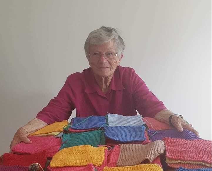 Member Rowena’s mother Peggy with some of her many knitted squares