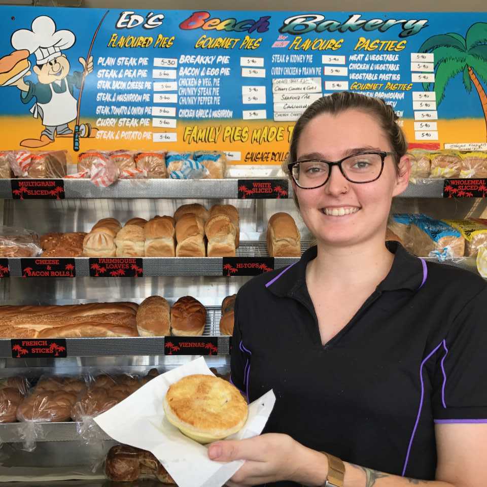Cleressa Clark of Rainbow Beach holds the famous corn beef and white sauce pie from Ed’s Beach Bakery at Rainbow Beach - list