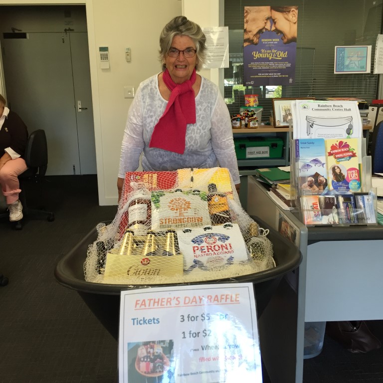 Ellie Butterfield has a wheelbarrow full of alcohol at the Rainbow Beach Community Centre ready for you to win for a dad on Father's Day