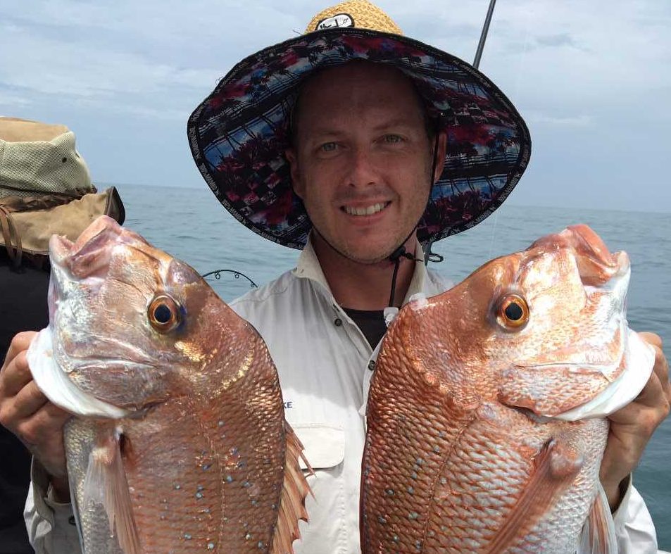 Dan with a pair of snapper with a bagged-out boat