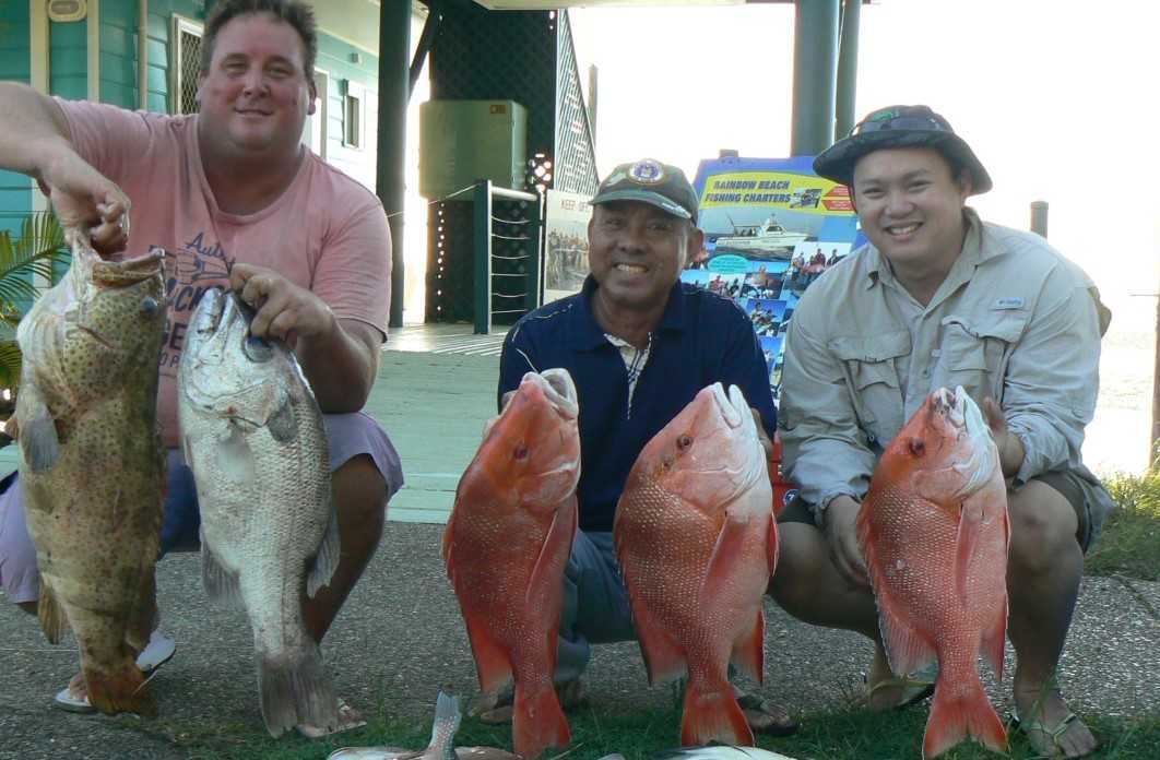 Mick with his cod and 4.7kg pearl perch, Nguyen and his father with a nice haul.
