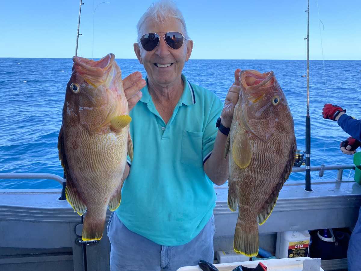 Fishing Club President Jim George with two nice maori cod caught a few kilometres off Rainbow Beach