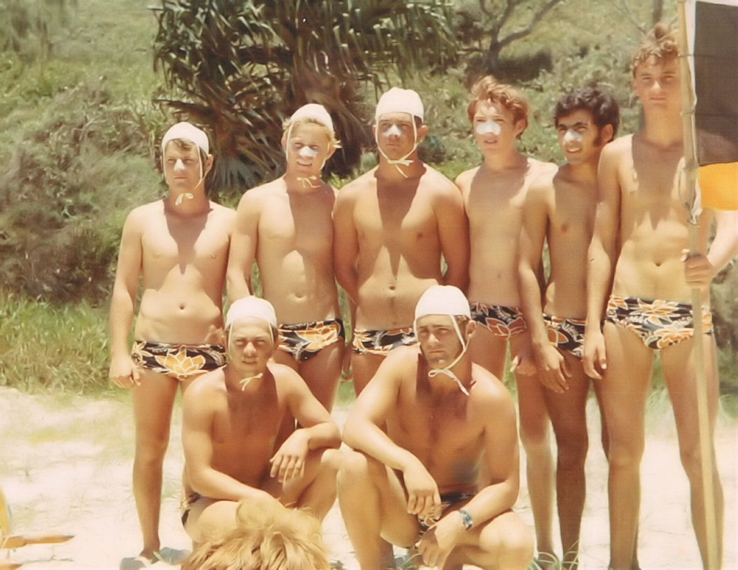 Back: Greg Biddle, Larry Dawson, George Day, Robin Perro, Allan Deen, Wayne Hewitt, Front: Billy Nolan, Garry Hewitt. They are wearing the togs they had to buy the day before to enter the March Past in.