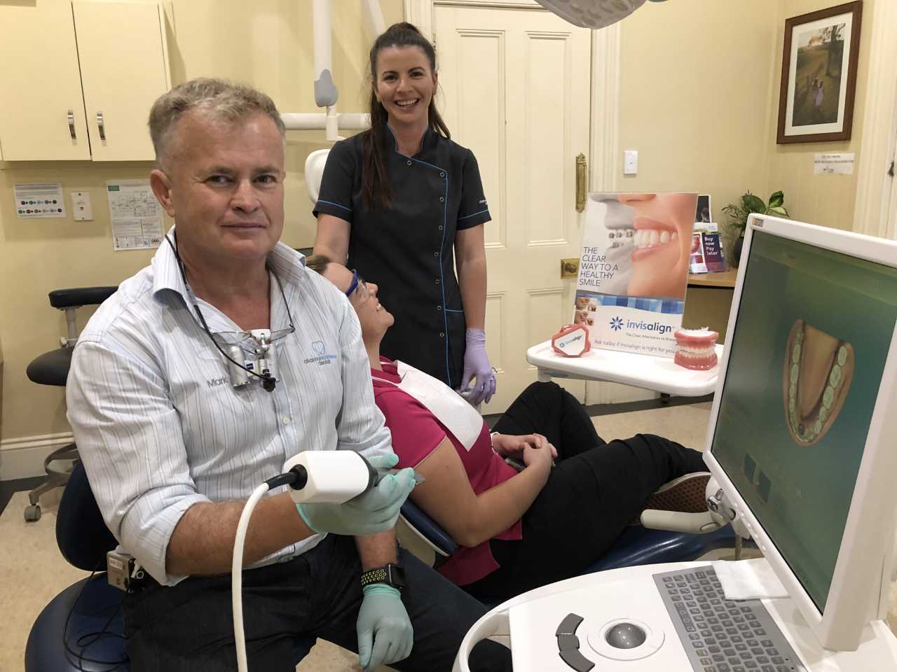 Channon Lawrence Dental’s Dr Mark showing Dental Assistant Kym and Oral Health Therapist Ashley (seated) the latest Invisalig