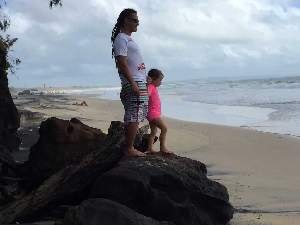 Edwin Hapi and Zia McPherson  play on the rocks at Rainbow Beach - just the day before this rock was hardly exposed!