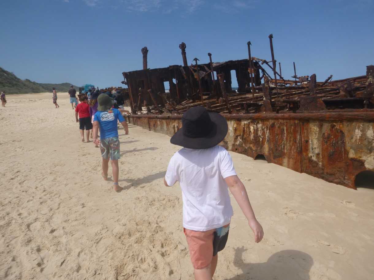 Kids view the majestic wreck of the Maheno