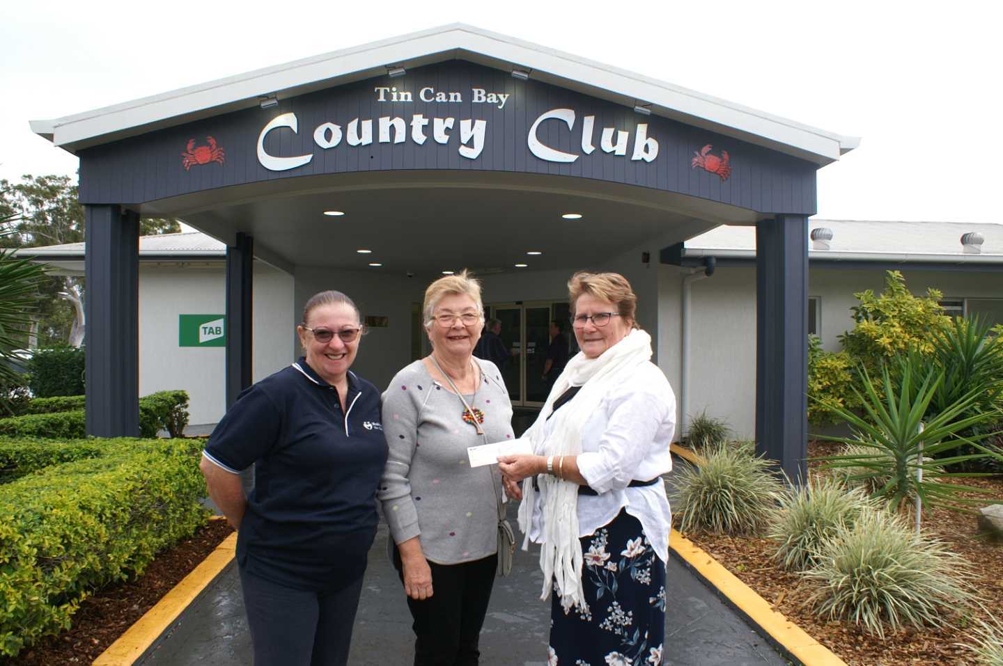 Julie Thorne and Julie Collins from TCB Meals on Wheels with TCB Country Club Treasurer Janet Reibel and a donations for $1000