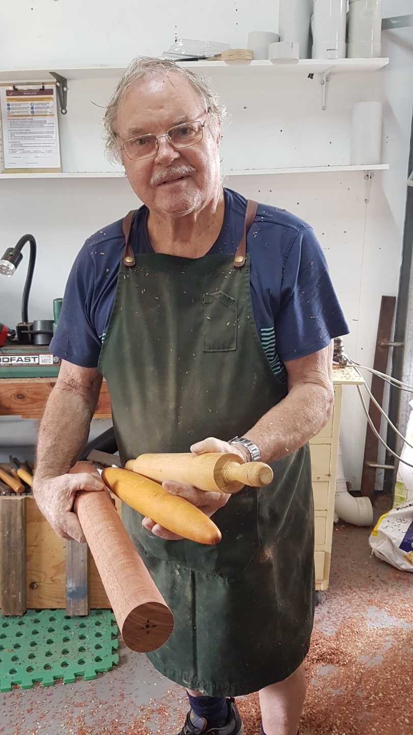Shed member and lathe master Paul Oliver, showing rolling pins made at the Shed and ready for sale at the TCB Markets 