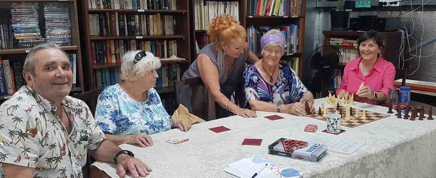 Bruce, Marie, Carolyn, Mary and Fiona enjoying friendly banter while strategising their chess moves at the Men’s Shed! 