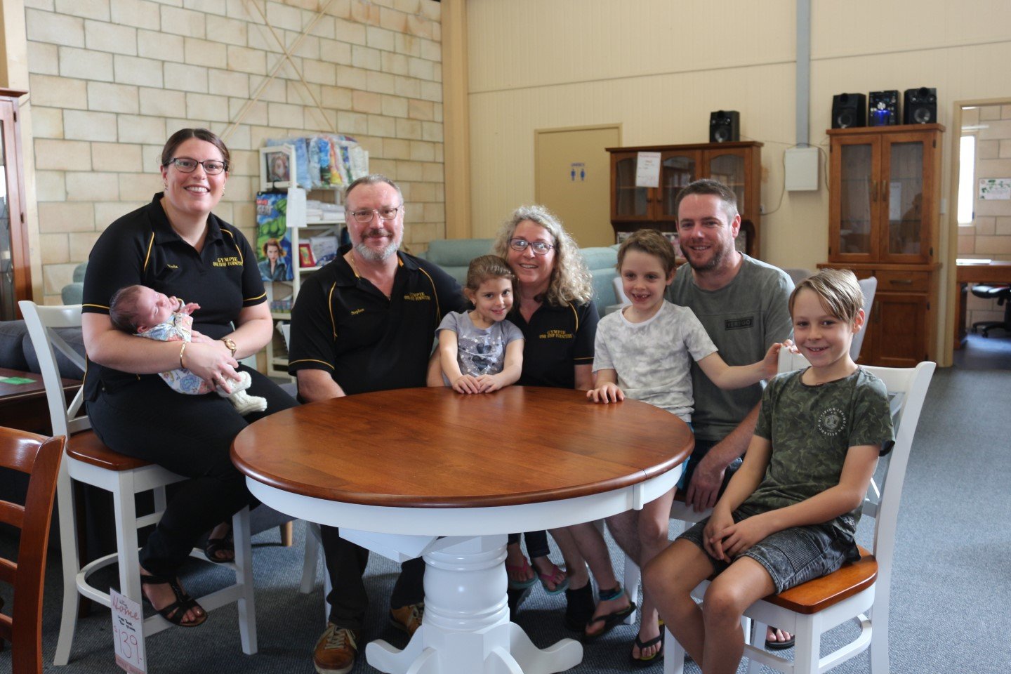Gympie One Stop Furniture - Owners of the new business, Nicola Garneys with baby Sophie, parents Stephen and Gaenor Garneys with granddaughter Isla, partner Russell Wegner with his sons Nathan and Ashton