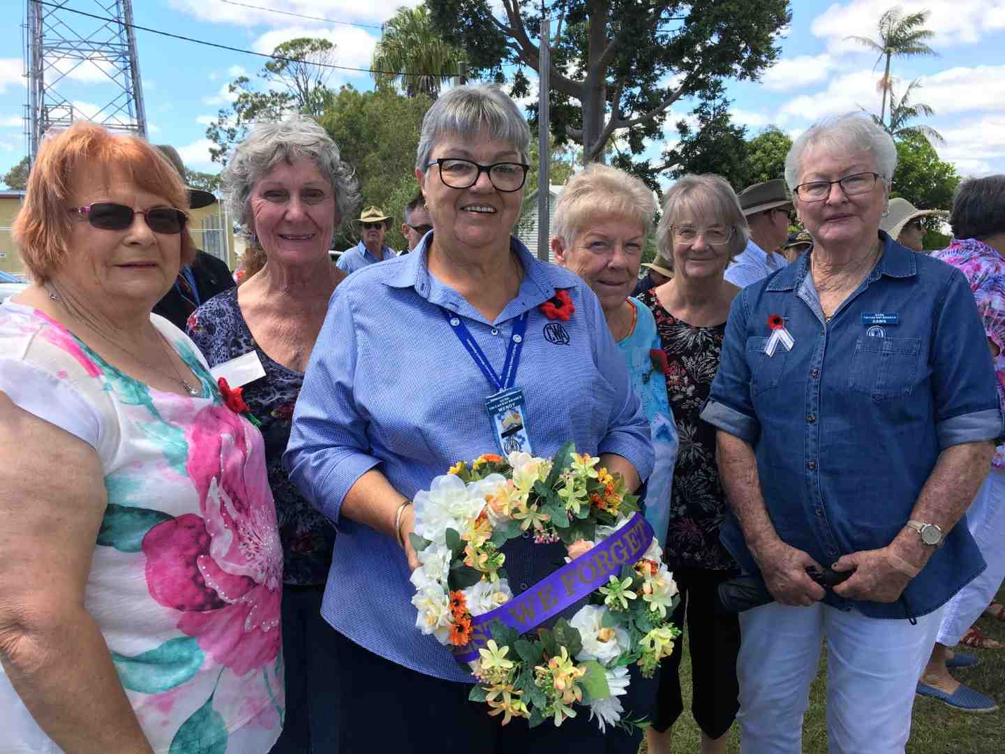 Members of the Tin Can Bay QCWA, Linda, Jill, Wendy, Robyn, Brenda and Dawn with the wreath they presented on Remembrance Day