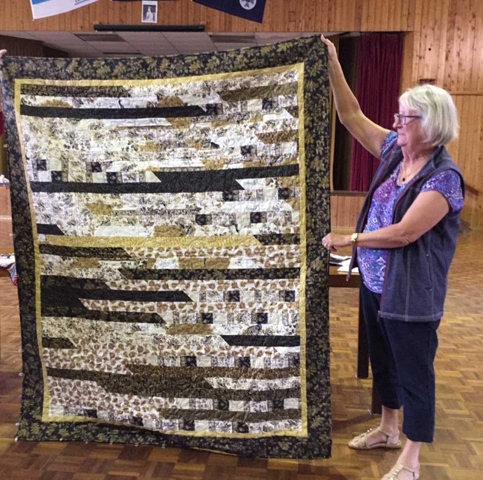 June Fraser shows off her quilt - join the Tin Can Bay Quilters on Tuesdays