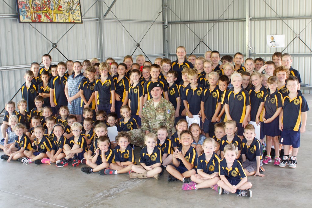 Trooper Branden Robb was bombarded with questions when he visited Rainbow Beach State School 