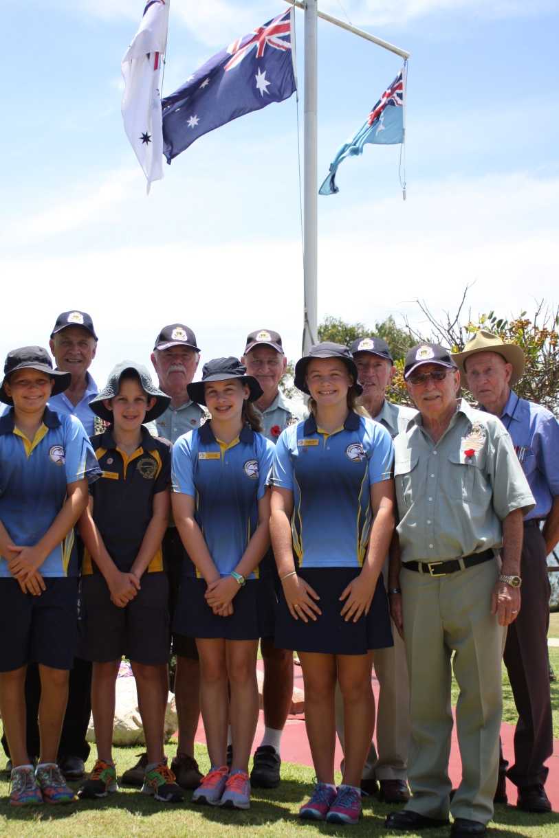 Rainbow Beach RSL Sub Branch members Bob Bliss, Trevor Ansell, John Molkentien, Pat Nayler OAM, Len Vickery, with (front) Rainbow Beach State School students Archie Gilmore, Charlie Kingsley, Ruby Falconer, Annie White and President Joe Casey after the 2016 Remembrance Day service 