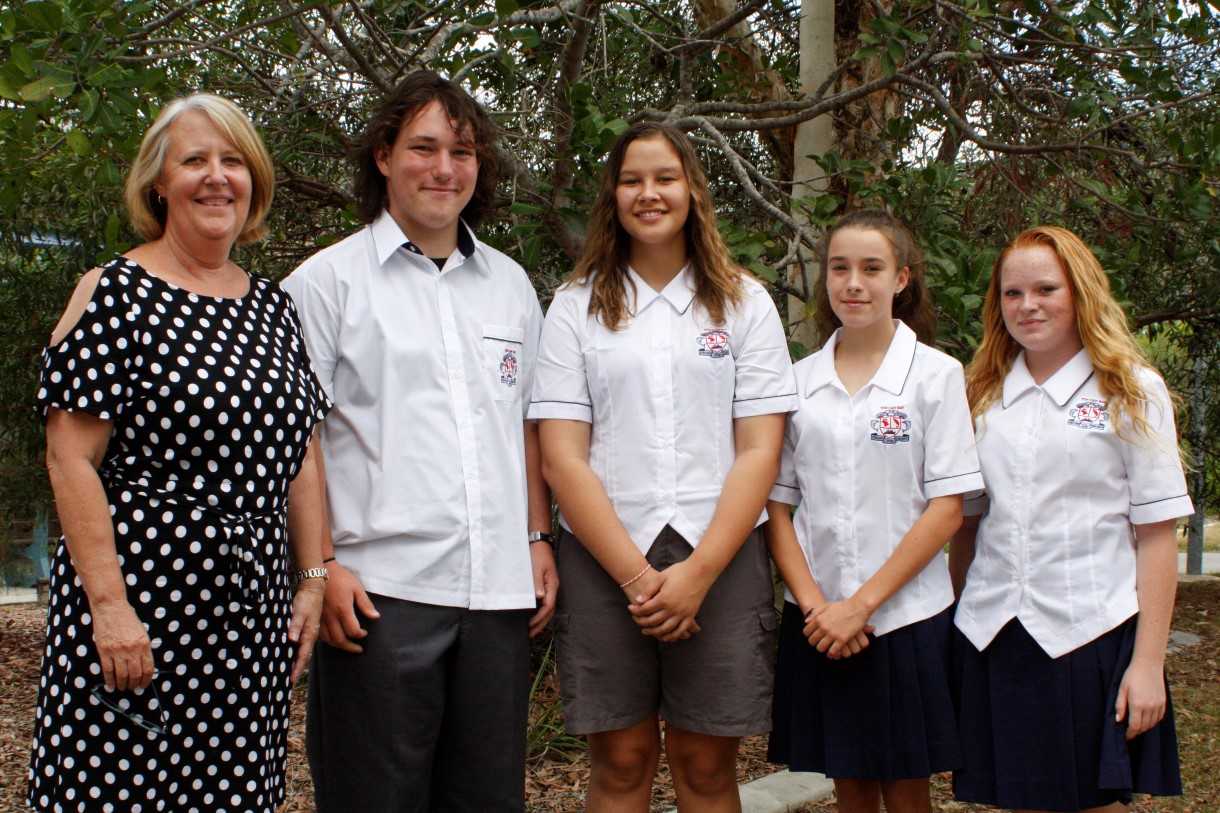 Principal Desley Kirby congratulates Secondary School Captains Braden Gray, Tehmia Masri, Vice Captain Anna Dunstan, and Student Leader Chelsea Brennan