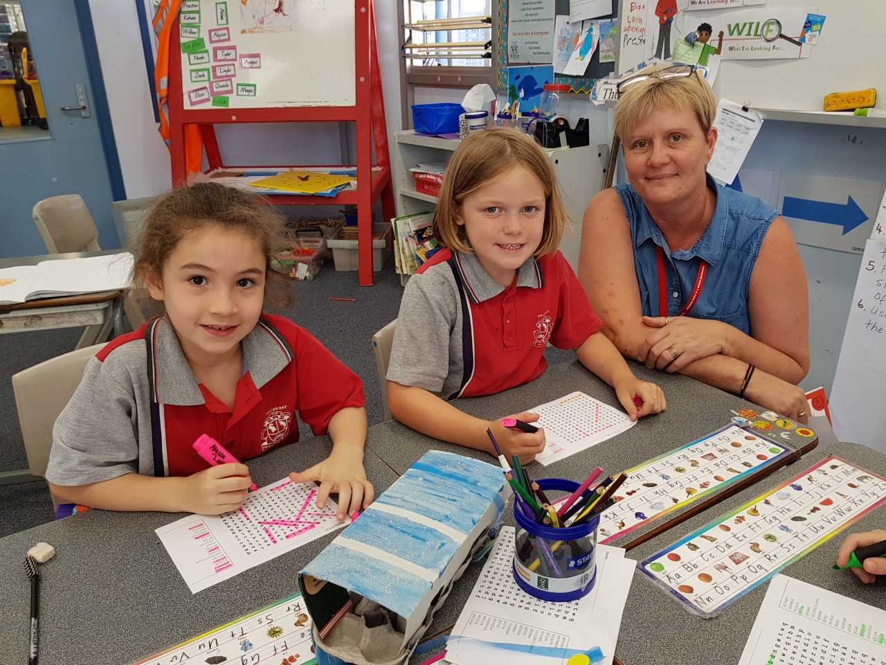 Chappy Karen helping Alyssa Latimore Eliza O’Driscoll find a word at Tin Can Bay School