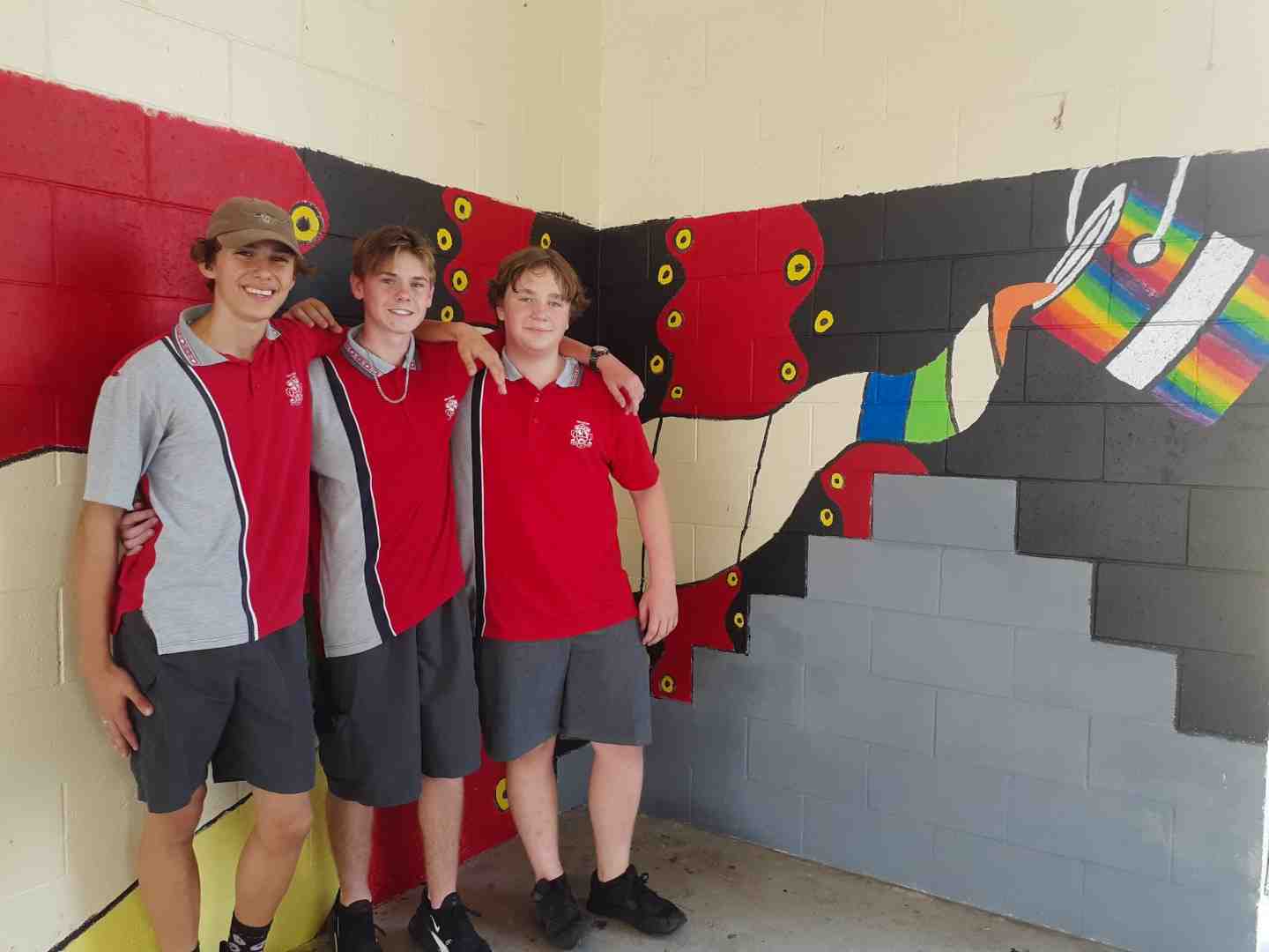 Year 9 students Rakeen, Blake and Mark, who are helping to complete the artwork at the Multi Purpose Space at Tin Can Bay school