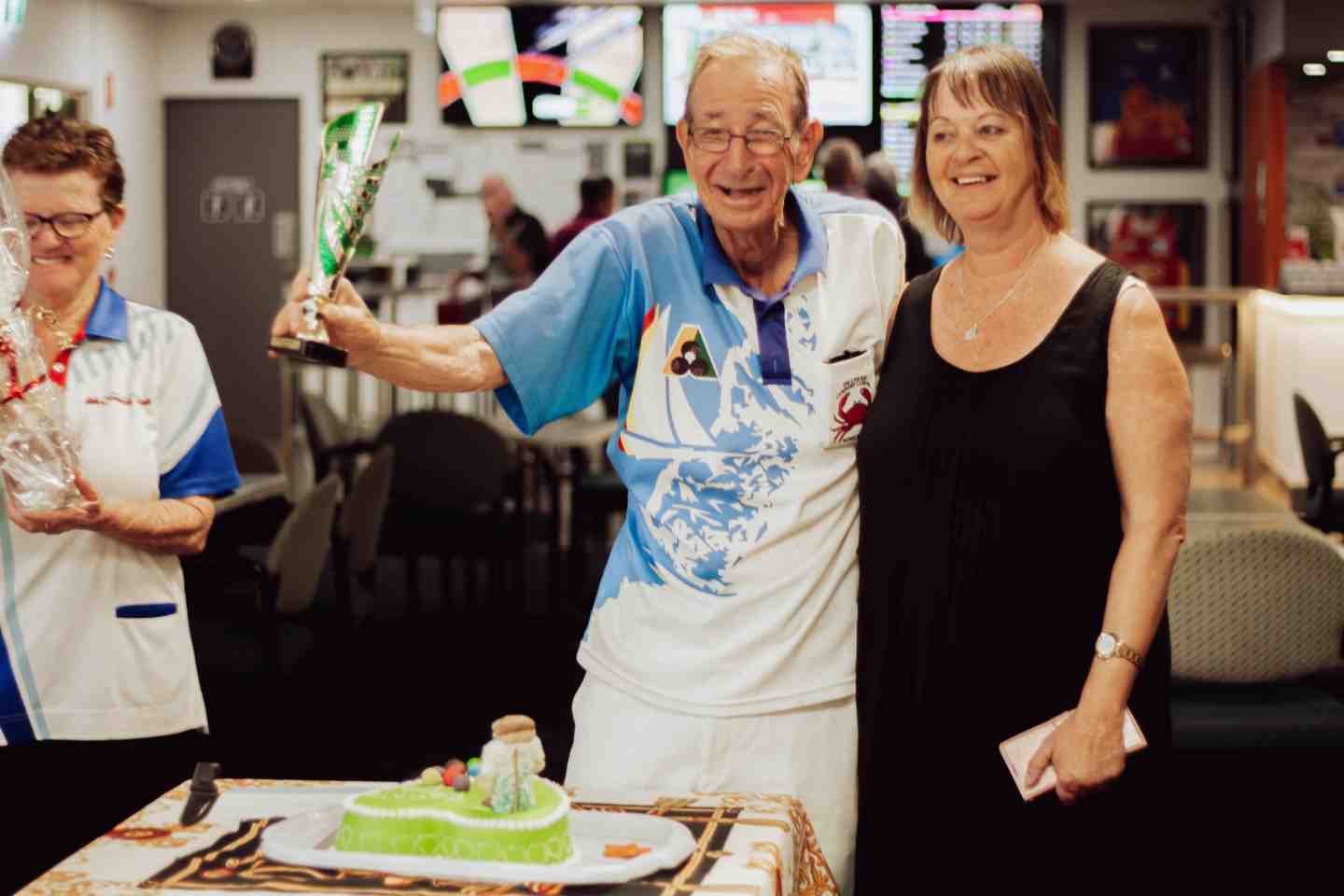 Ladies President Rowena Giles and the Tin Can Bay Ladies Bowls Club presented Ron Sollaye with a gift and cake to say thank you for all he has done for the Ladies Club joined by daughter Linda