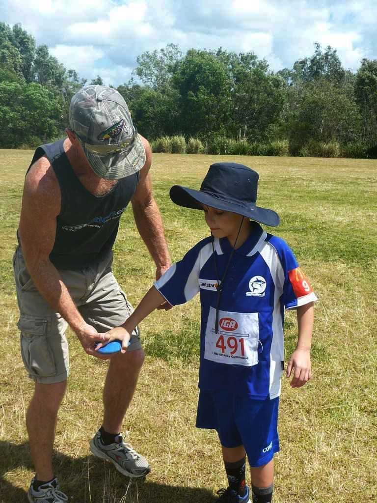 Ari Skennerton is guided by coach Bill McKechnie on correct throwing technique