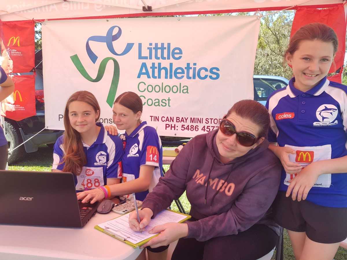 Little Athletics - Renee Burton filling in registrations at the sign-on day at the Tin Can Bay Markets
