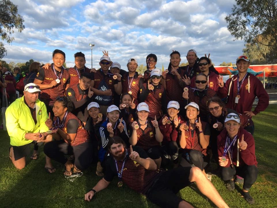 23-year-old Shane Berkhout won a bronze medal at the Australian Dragon Boating Championships, behind him is the Queensland Premier Men and Women’s Relay Teams