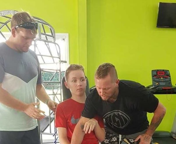 Tristan Sik is building strength with Dad and Personal Trainer Mark at the Rainbow Beach Gym Image supplied