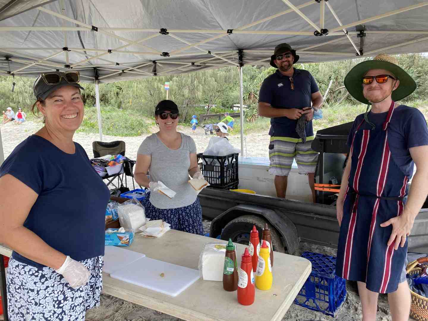 The Sandcastle Competition was so popular, Rainbow Beach State School P&C, Sandra Lindenberg (Treasurer), Simone, and Steve Bennett (Principal) and Jed Elmer (President) sold out of sausages!