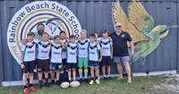 Rainbow Beach Junior Rugby League players proudly display their brand new jerseys. Pictured with Coach Steve Bennett and major sponsor Drew Gardiner from Rainbow Beach Tackle World.