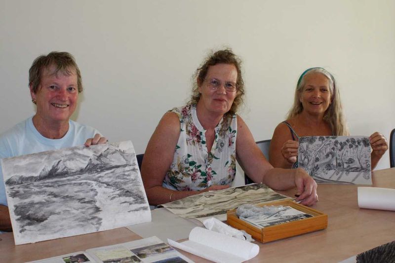 Gayle Young, Ann Thornton and Ze show off their creations from the library art workshops