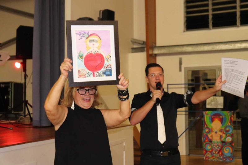 Organiser, Leonie Guerin with Kylie Betteridge's ‘Andrea’ as Andrew Hawkins auctions each masterpiece