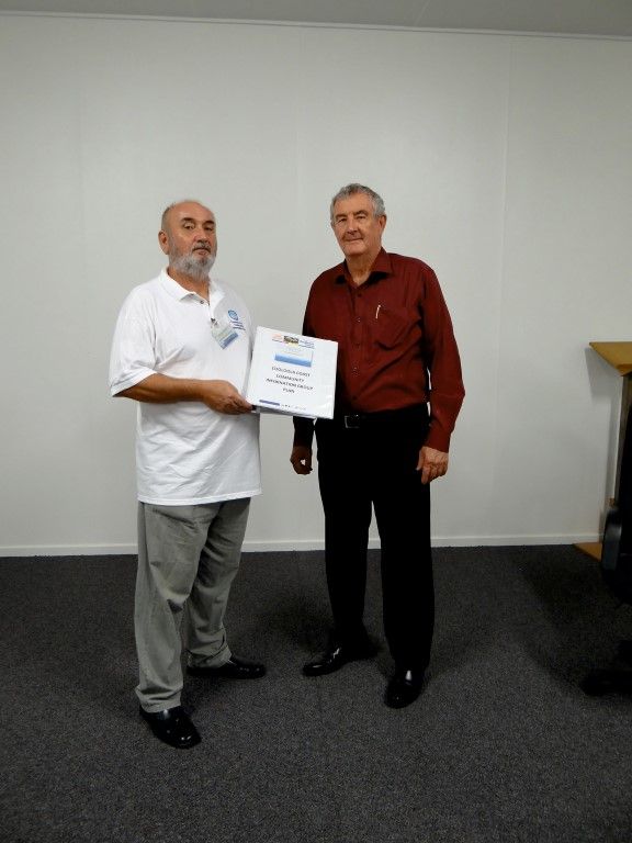 Chairman Terry Steele handing the Cooloola Coast Community Information Group plan to Mayor Ron Dyne