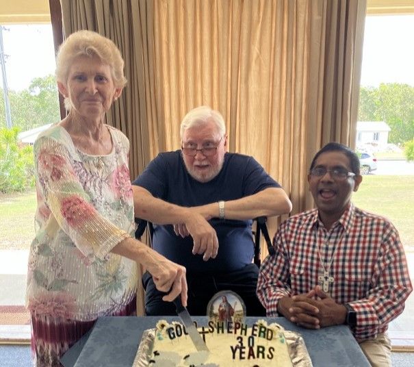 Annette Collins, Rev. Kev Lewis, and Rev. Shaji Joseph cut the cake made by Sandra Strohfeldt. Photo supplied by Beris Traine
