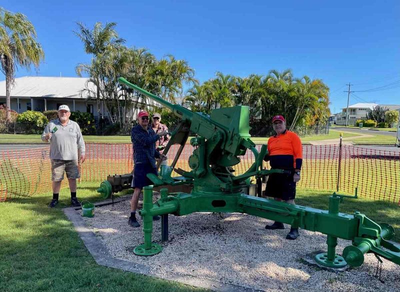 Members of the Men’s Shed hard at work repainting the Bofors Gun