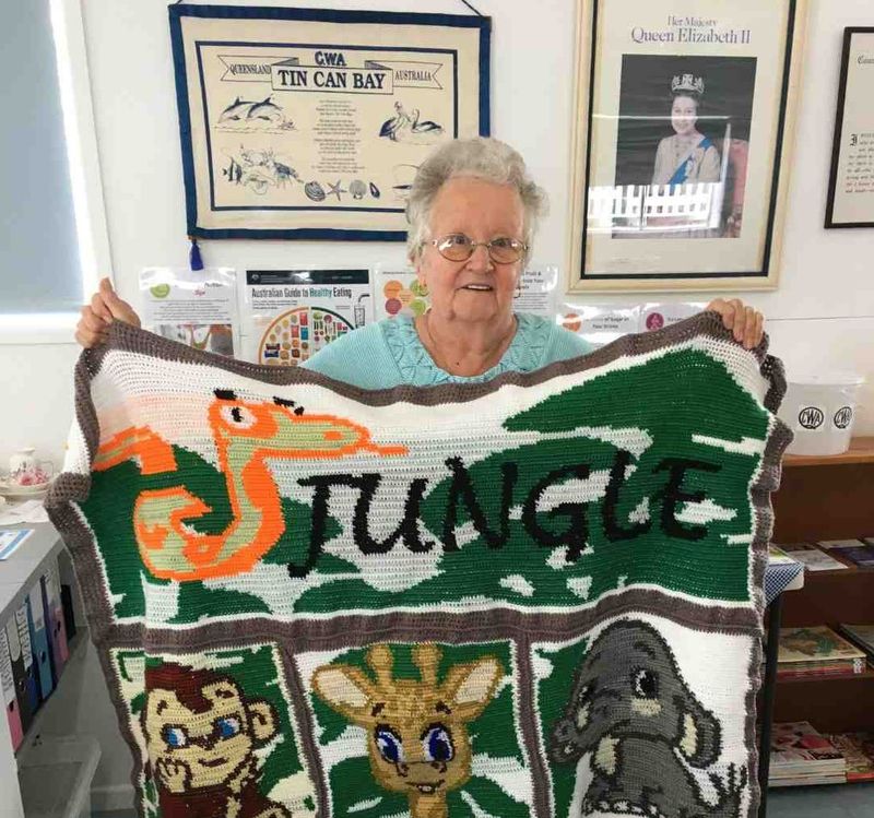 Mollie with her crocheted jungle theme rug, her entry in the QCWA Knitting Competition