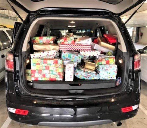 The back of the Manager Brad Robb’s car packed full of presents on their way to Community Action