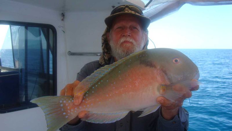 Fishing Club member Ron Cox with a parrot
