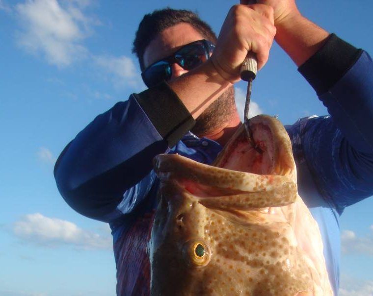 Travis struggled with his monster cod for a photo