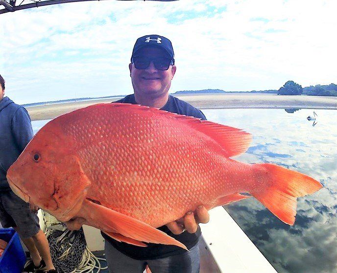 All smiles for Lex from Warrick on board Rainbow Beach charter boat Baitrunner