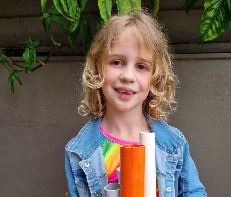 Silvie shows off her finished frog hotel, ready to welcome some green guests.