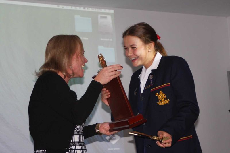 Principal Dr Julie Wilson Reynolds presents Kate with the Ammonite Award - St Hildas's Rowing's highest honour