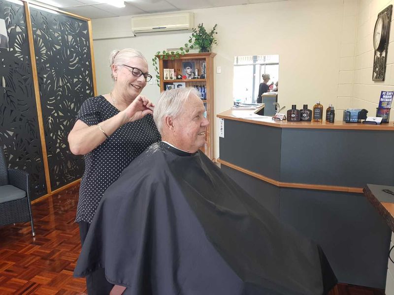 Barber Chris Challenor gives Trevor Booth a trendy trim