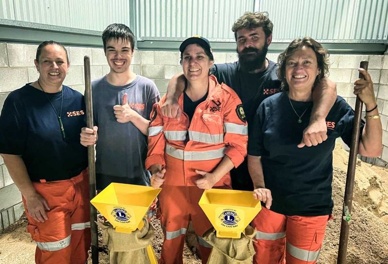 The Rainbow Beach SES crew give a thumbs up for the donation of the stands
